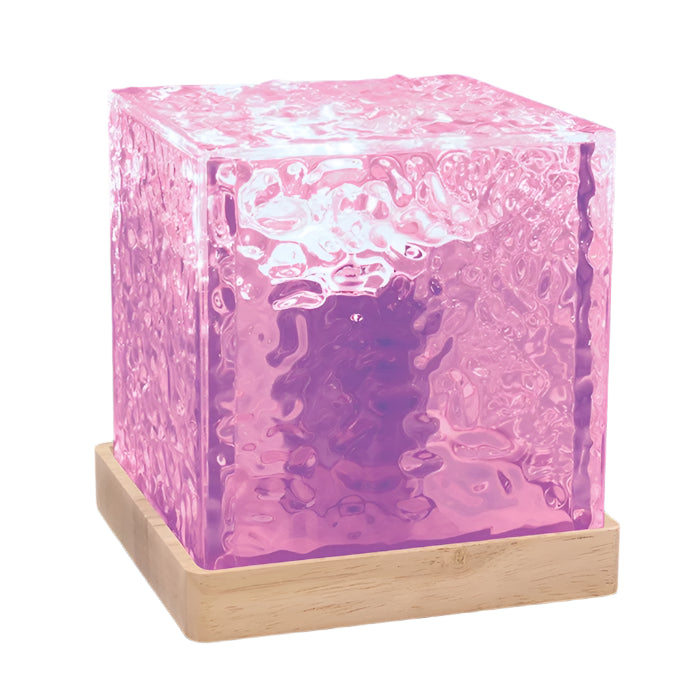 A purple LED cube lamp with a textured surface placed on a wooden base, illuminated to create a water wave effect.