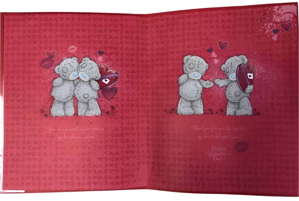 A Valentine's Day card featuring two teddy bears on a red background with hearts and the inside of the card displaying a romantic message.